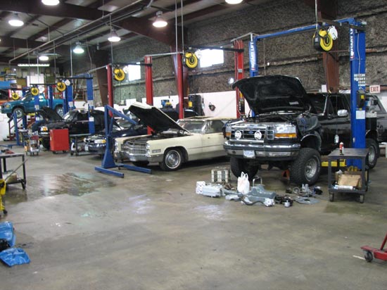 6_Ford_pickup_Cadillac_GMC_in_repair_shop