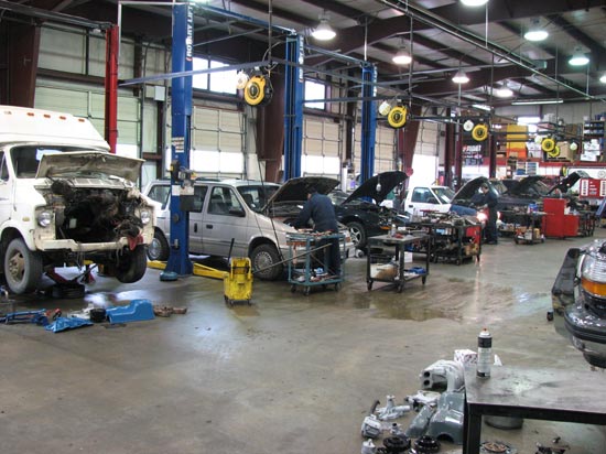 8_licensed_technician_Chrysler_minivan_in_repair_shop